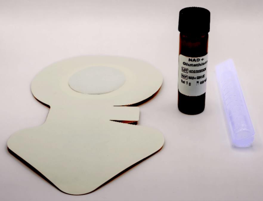 Push Patch kit contents: a shaped adhesive patch with a round pad, a small amber blend vial, and a clear graduated tube